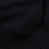 Close-up of the Canterbury Rakaia 2.0 Hoodie in black, highlighting the seam and pocket detail with visible stitching.