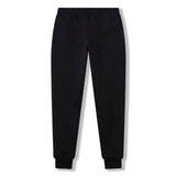 The Rakaia 2.0 Fleece Pant by Canterbury is shown laid flat against a white background, highlighting its black jogger-style design with an elastic waistband and cuffed ankles. Combining comfort and style, these men's track pants from Canterbury are a must-have for any casual wardrobe.
