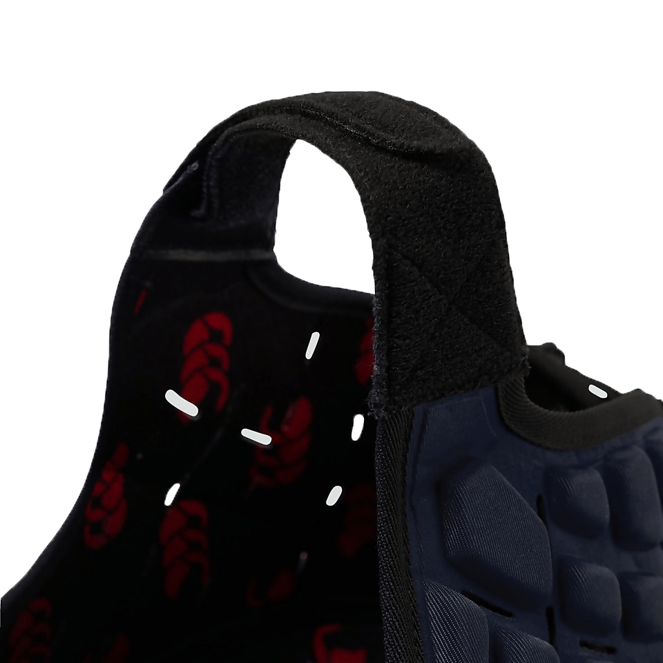 Close-up of a black and blue Canterbury Raze Headguard with Canterbury branding, a velcro strap, and padded cushioning.