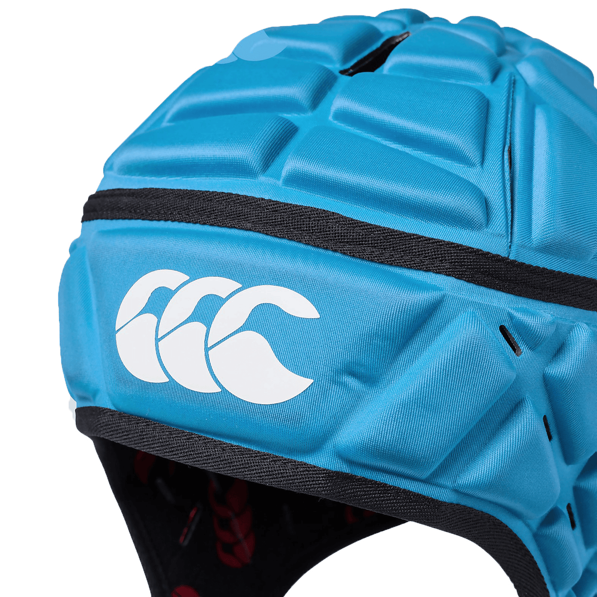 A close-up view of a blue Canterbury Raze rugby headguard with a logo of three curved lines on the side.