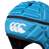 A close-up view of a blue Canterbury Raze rugby headguard with a logo of three curved lines on the side.