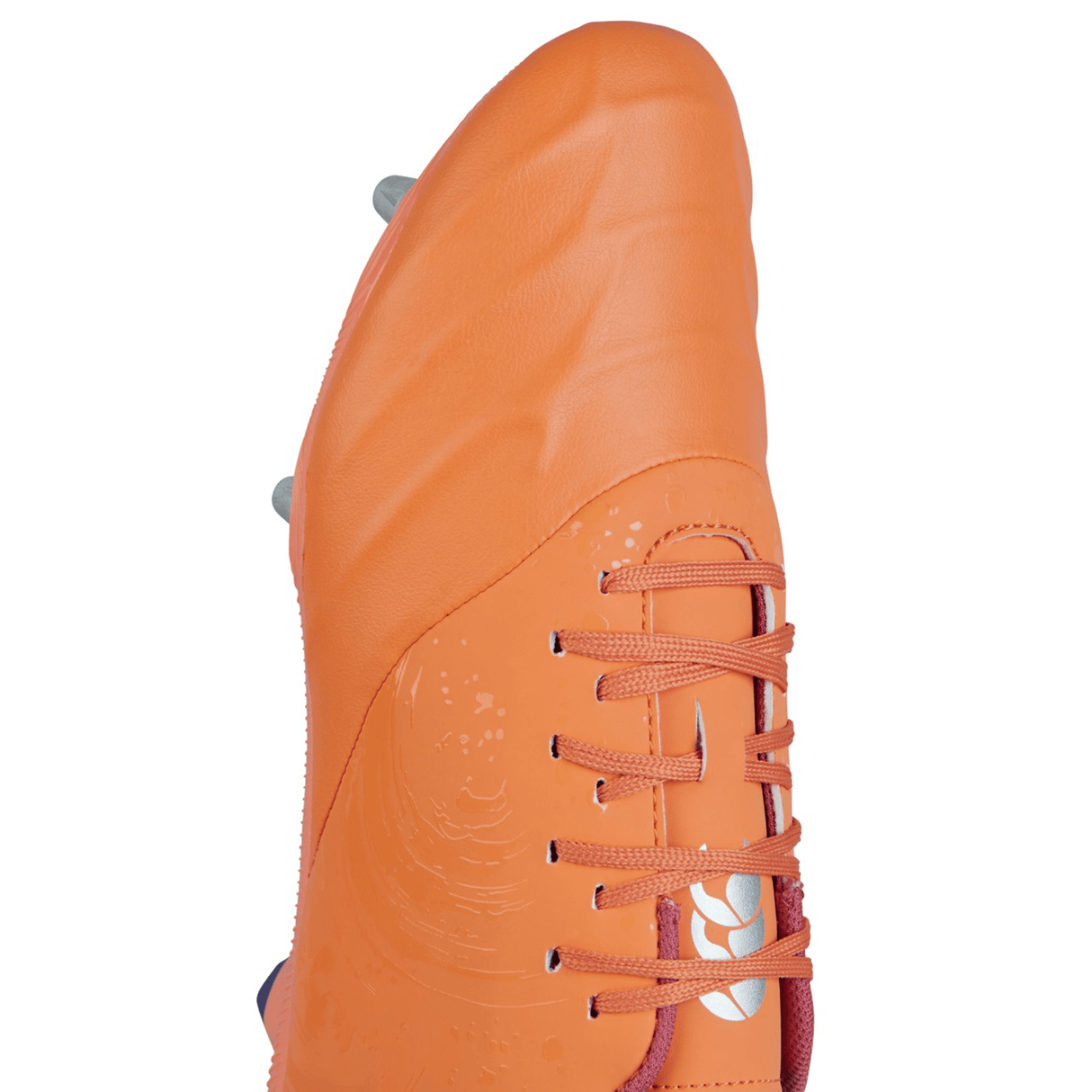The Canterbury Phoenix Genesis Pro SG in Orange Crush/Amber Yellow/Mars Dust is a soccer cleat designed for ultimate traction, featuring molded studs on the sole and adorned with pink laces and white branding.
