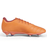 The Canterbury Phoenix Genesis Pro SG in Orange Crush/Amber Yellow/Mars Dust, a standout soft ground boot featuring metallic studs and red laces, is displayed on a plain white background. This cleat promises ultimate traction on the field.