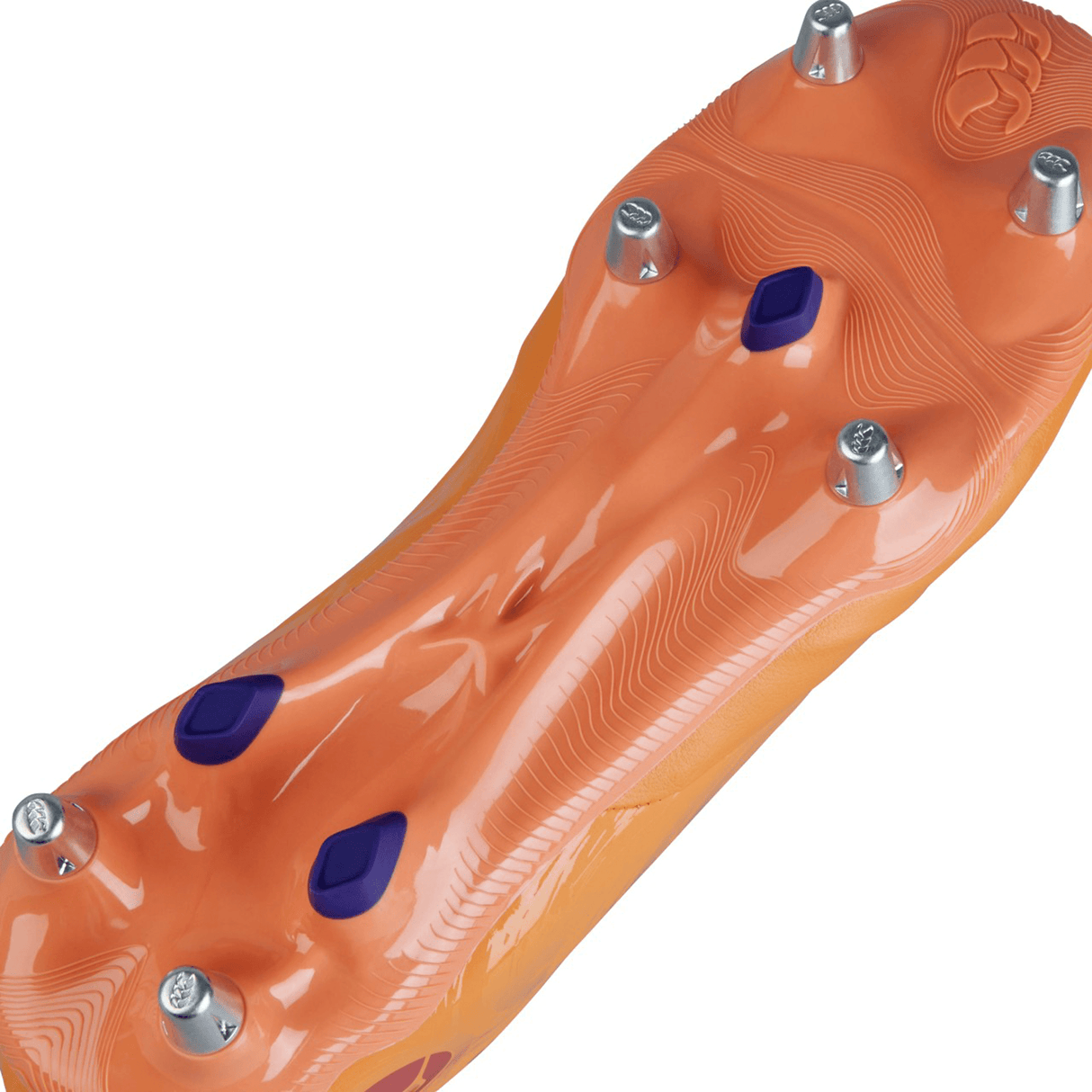 Close-up of the underside of a Canterbury Phoenix Genesis Pro SG - Orange Crush/Amber Yellow/Mars Dust, an orange sports shoe with metal cleats and blue accents designed for ultimate traction on soft ground.