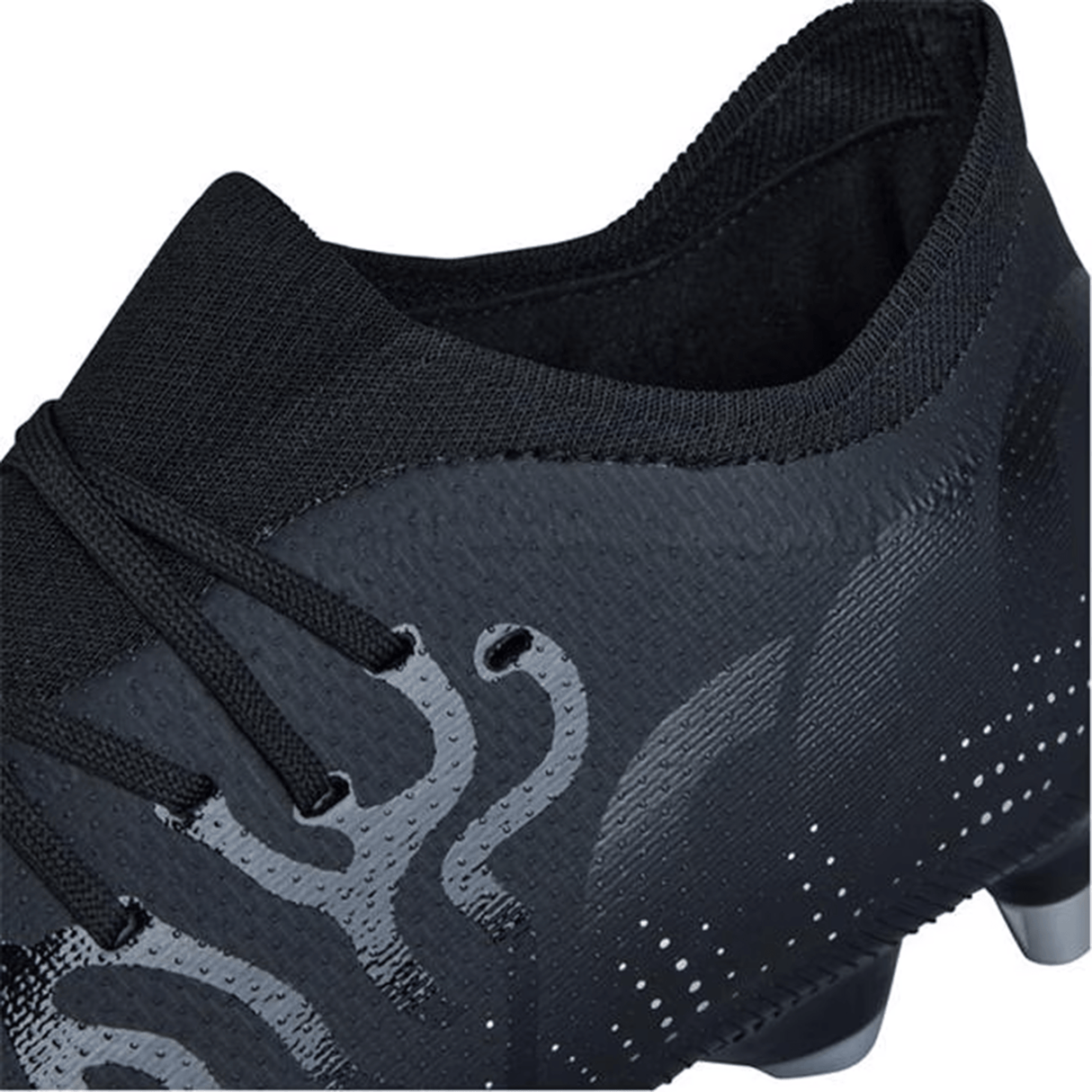Close-up of a black Canterbury Speed Infinite Pro SG soccer cleat with laces, featuring a textured design and minimalist patterns on the surface. Its lightweight construction offers swift agility on the field.