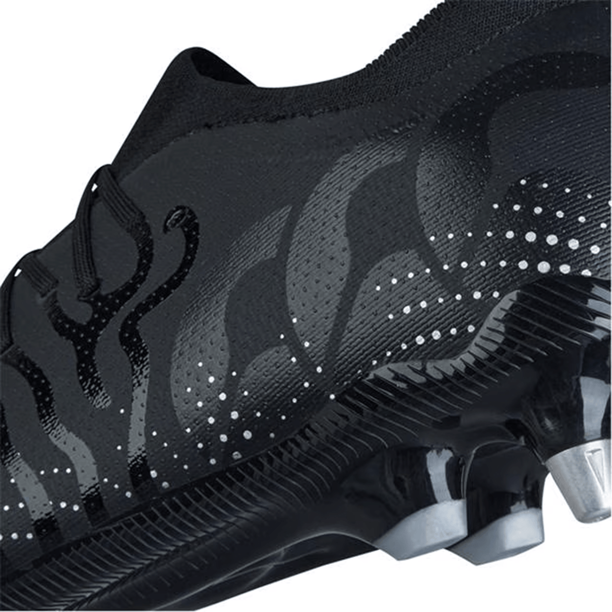 Close-up of a Canterbury Speed Infinite Pro SG soccer cleat in black with silver metallic accents, showcasing its lightweight design, textured dotted pattern, and spiked sole.