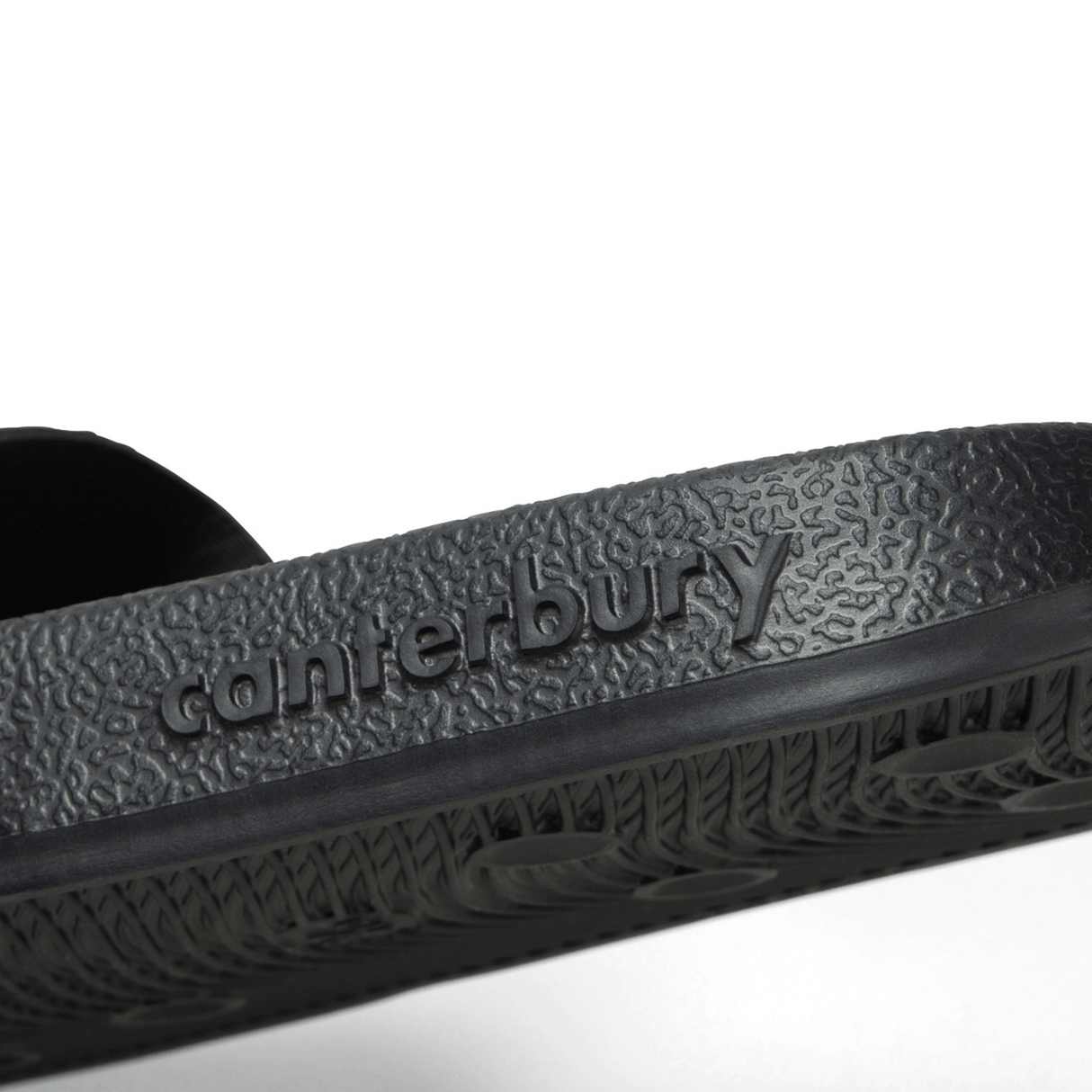 Close-up of the Canterbury Wide Fit Slide - Black, featuring the word "Canterbury" embossed on the side of the sole, designed for all-day comfort.