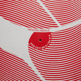 Close-up of a Canterbury Thrillseeker Play Rugby Ball texture with red patterns and instructions to 'moisten needle' before insertion.