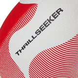 Close-up of a textured Canterbury Thrillseeker Play Rugby Ball with a red and white pattern, displaying the words "thrill seeker" printed in black.