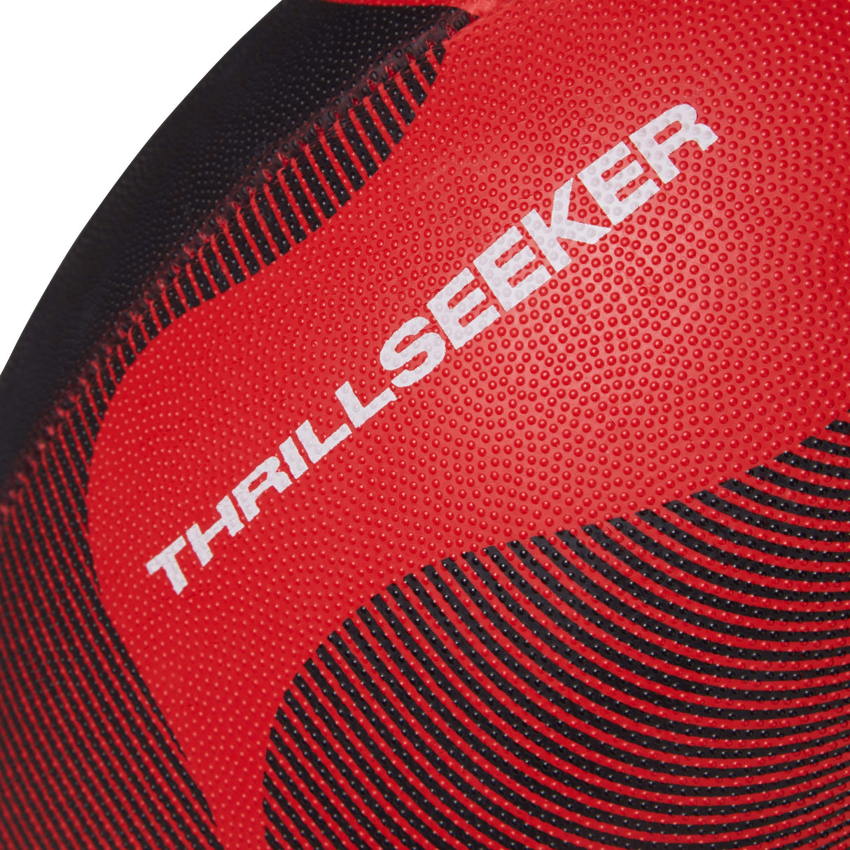 Close-up of a red and black textured Canterbury Thrillseeker Play rugby ball with the word "thrillseeker" printed on it.