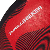 Close-up of a red and black textured Canterbury Thrillseeker Play rugby ball with the word "thrillseeker" printed on it.