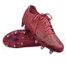 A pair of Canterbury Stampede Groundbreak Pro SG soccer cleats in Mars Dust/Orange Crush/Amber Yellow, with one standing upright and the other on its side highlighting the TPU outsole metal studs.