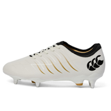 The Canterbury Phoenix 2.0 Team SG - White rugby boot by Canterbury features gold and black accents, metal studs for soft ground play, and a black logo on the heel.