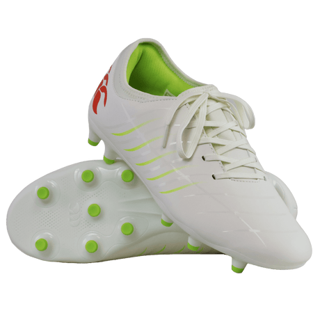 A pair of Canterbury Phoenix 2.0 Team FG Rugby Boots in Snow White and Tangerine Tango is shown, with one boot upright and the other on its side displaying the sole with colored studs—these firm ground boots from Canterbury merge striking style and top-level performance for optimal play on the rugby field.