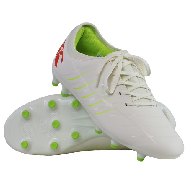The Canterbury Phoenix 2.0 Team FG football boots in Snow White/Tangerine Tango feature a durable white design, green studs and accents, a red logo on the heel, with one boot shown upright and the other on its side.