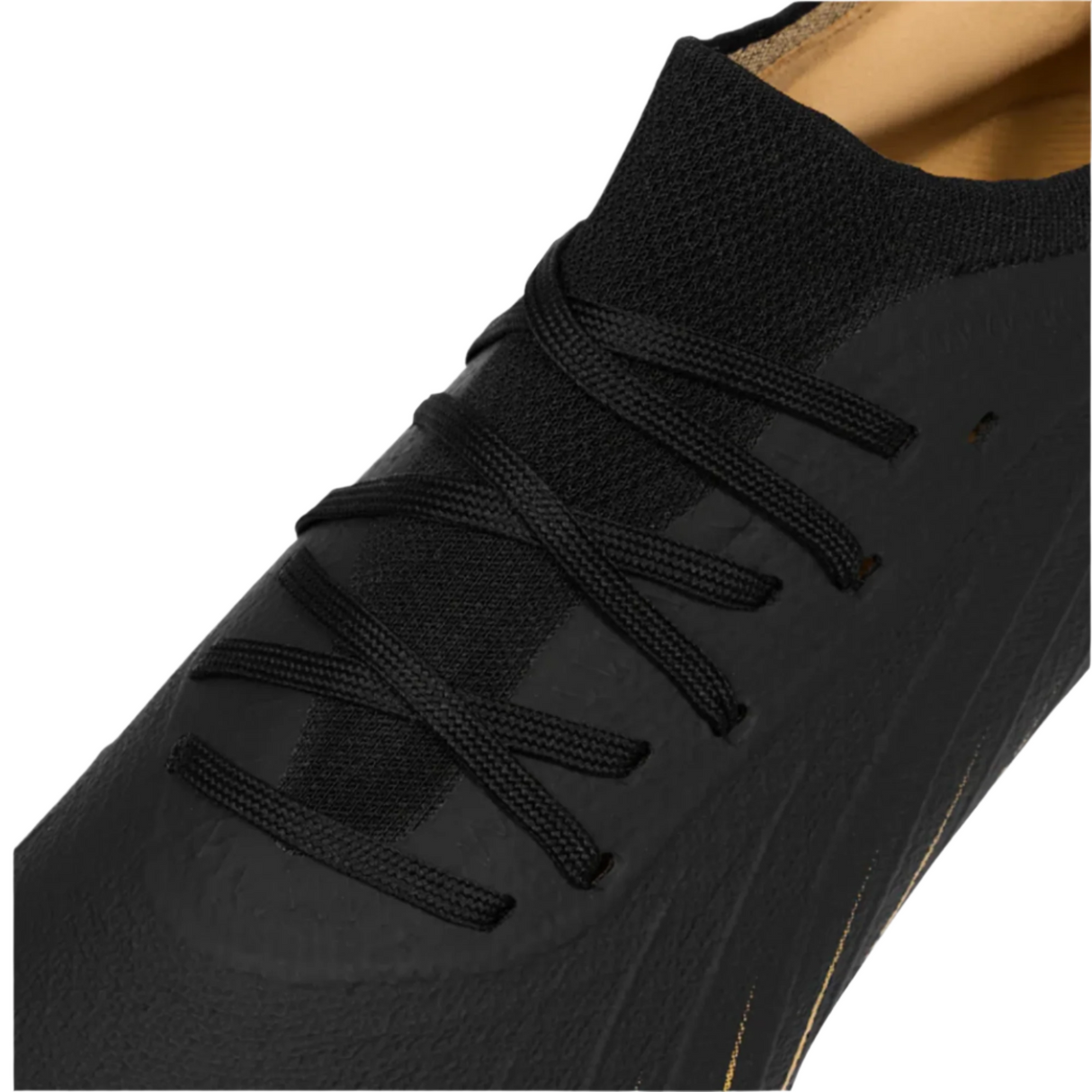 Close-up of the Speed Falcon Elite SG by Canterbury in black, featuring black laces, a mesh tongue, and a textured synthetic upper inspired by soft ground boot design.