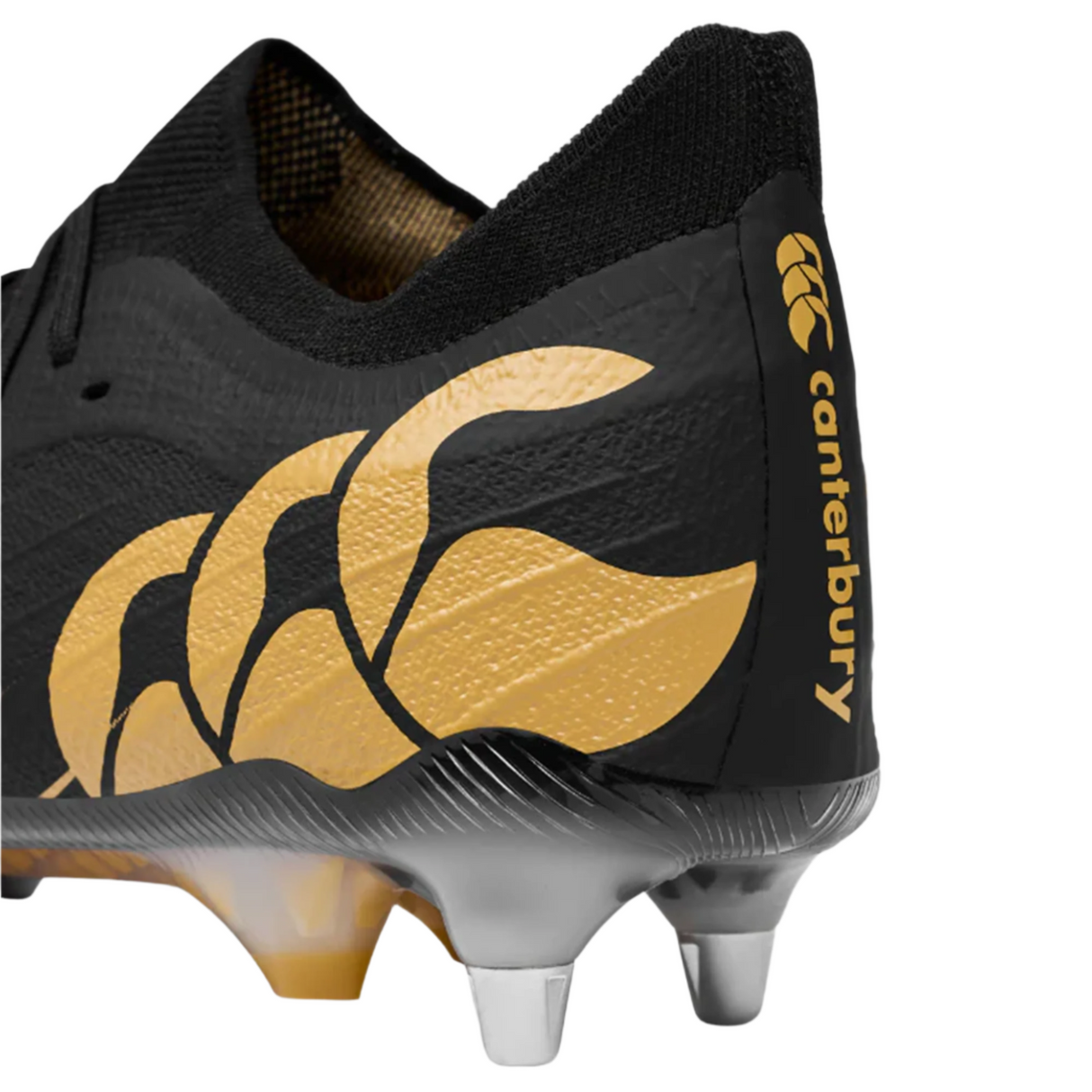 The Speed Falcon Elite SG by Canterbury in black features metal studs, the Canterbury logo and branding on the heel, and offers style and performance for soft ground play.