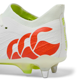Close-up of the heel of the Canterbury Speed Falcon Elite SG - Snow White/Tangerine Tango rugby boot; features red wave logo, yellow "Canterbury" text, metal studs, and light green sole—made for elite performance on soft ground.