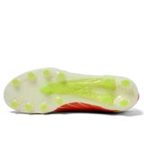 Bottom view of the Canterbury Speed Falcon Elite FG in Tangerine Tango/Snow White by Canterbury, a lightweight football boot with a white sole, lime green studs, and a textured midfoot plate ensuring exceptional grip on firm ground.