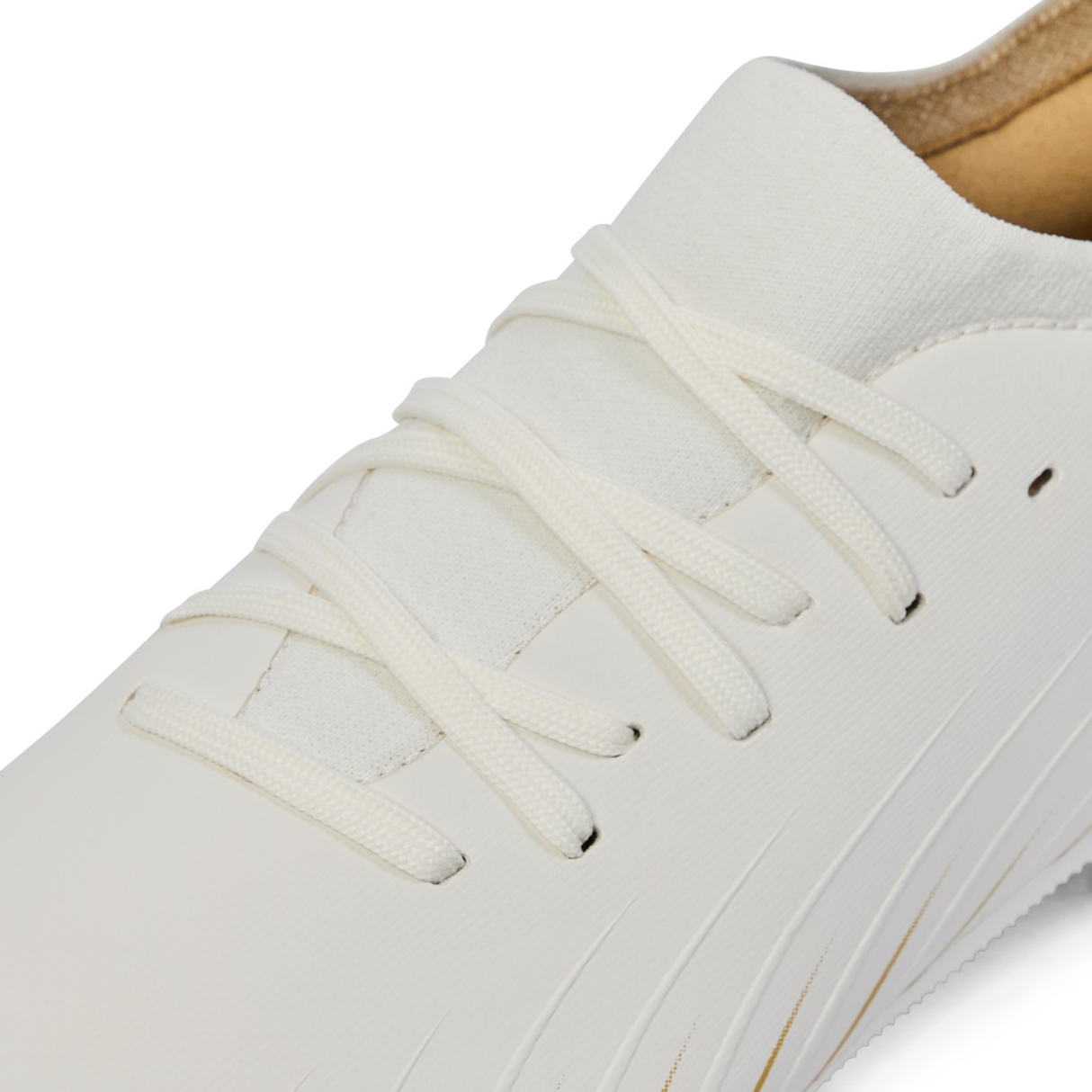 Close-up of the Canterbury Speed Falcon Pro SG - White sneaker, featuring white laces and a textured upper, inspired by the lightweight design of Canterbury's rugby boots.