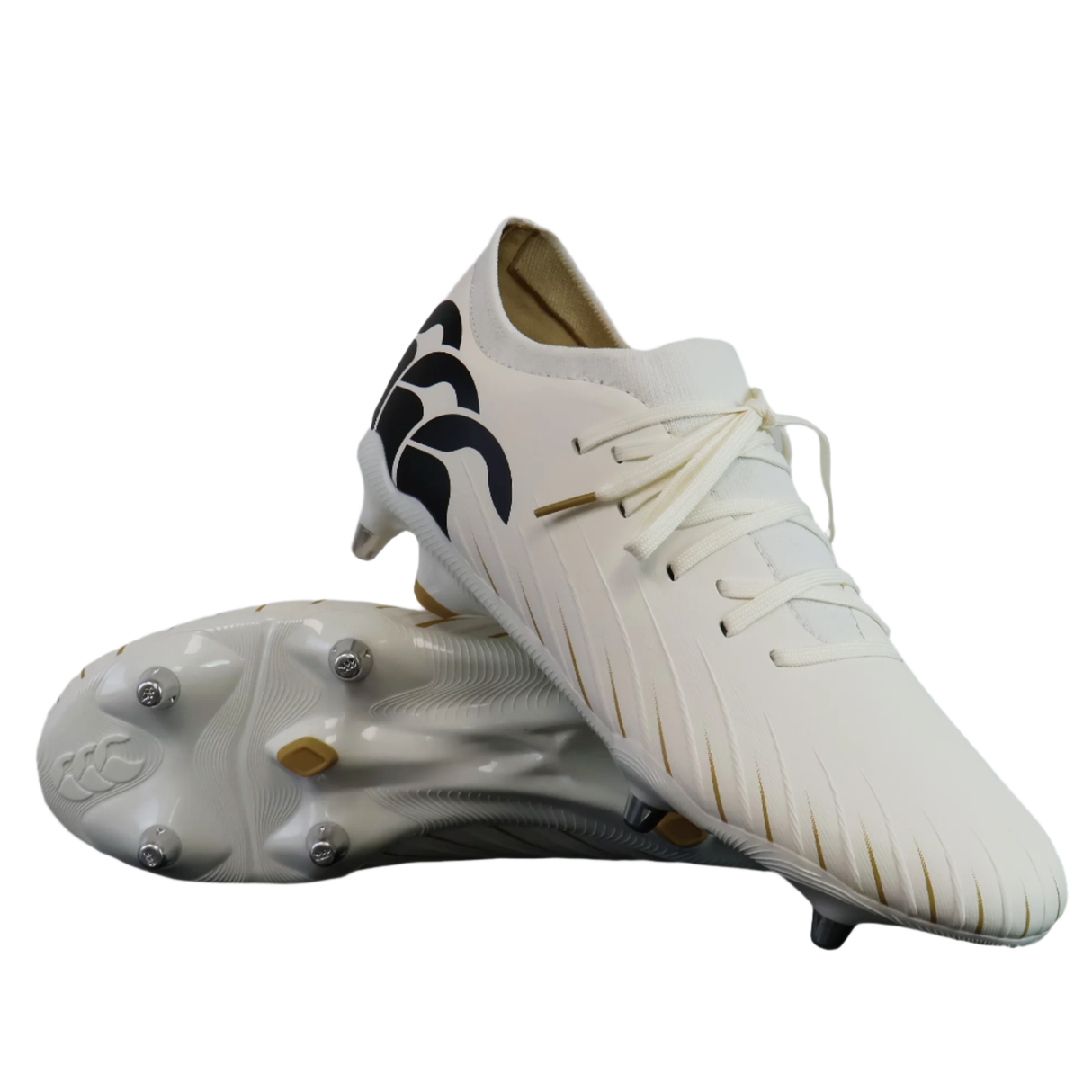 A pair of Canterbury Speed Falcon Pro SG - White rugby boots, featuring black wave accents on the heel and gold-tipped laces, with one shoe displayed atop the other.