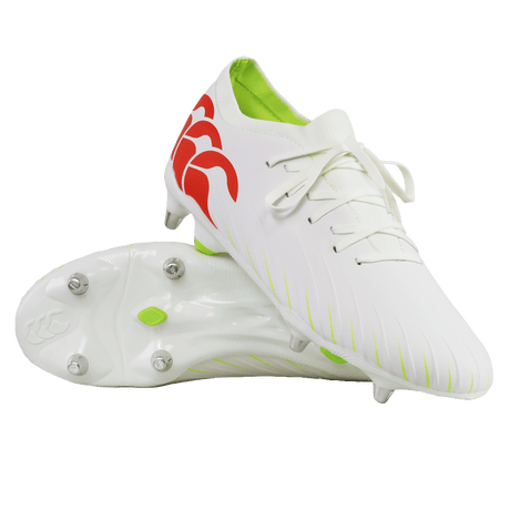 The Canterbury Speed Falcon Pro SG rugby cleats in Snow White/Tangerine Tango feature red logo accents, a neon green interior, and metal studs, displayed against a white background.