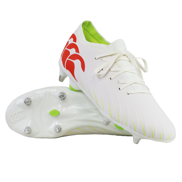 The Canterbury Speed Falcon Pro SG rugby cleats in Snow White/Tangerine Tango feature red logo accents, a neon green interior, and metal studs, displayed against a white background.