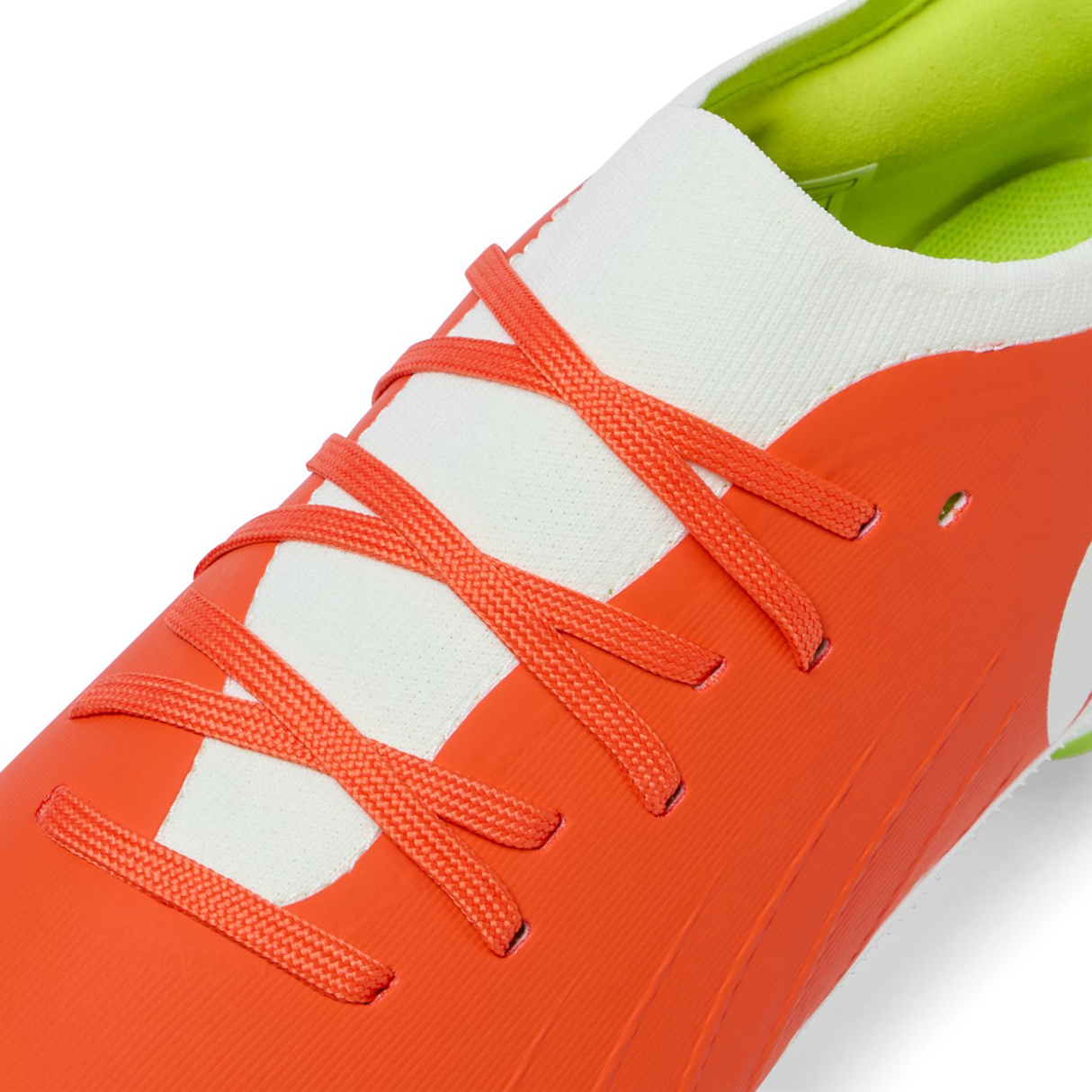 Close-up of Canterbury Speed Falcon Pro SG boots in Tangerine Tango/Snow White, featuring a white tongue, tangerine laces, and a green inner lining—lightweight rugby boots from Canterbury designed for agile performance.