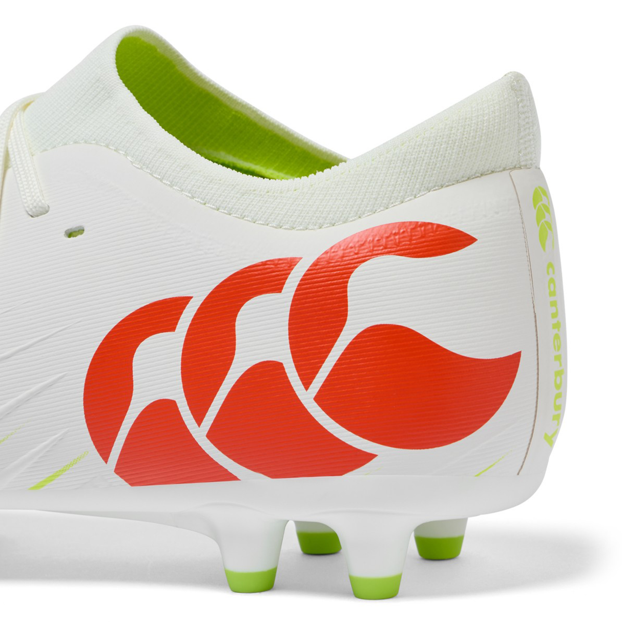 Close-up of the heel of a Canterbury Speed Falcon Pro FG - Snow White/Tangerine Tango soccer cleat, featuring a red Canterbury logo and green stud tips on the sole.
