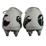 The Canterbury Speed Falcon Team SG - White rugby boots by Canterbury feature black abstract heel designs. Ideal soft ground boots for agile players, offering a blend of style and performance.