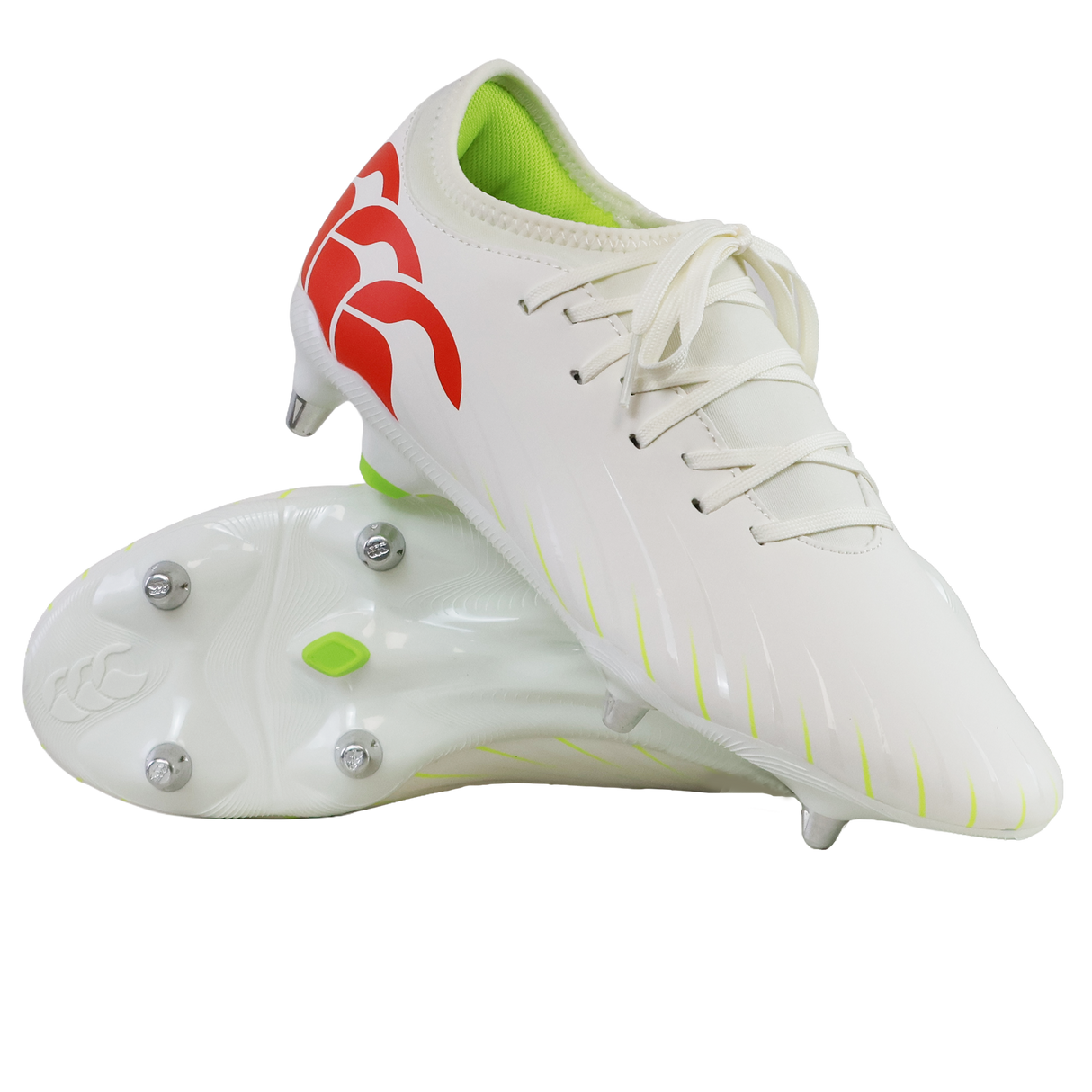 A pair of Canterbury Speed Falcon Team SG soccer cleats in Snow White/Tangerine Tango, featuring a red logo, neon green interior, and metal studs; one shoe stands upright while the other shows its sole.