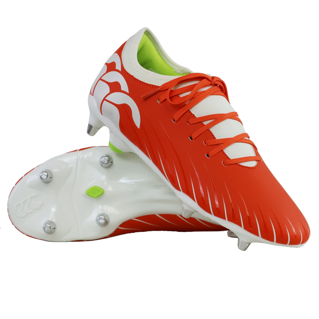 A pair of Canterbury Speed Falcon Team SG rugby boots in Tangerine Tango/Snow White, one upright and one on its side, featuring metal studs and a lime green inner lining.