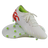 A pair of Canterbury Speed Falcon Team FG soccer cleats in Snow White/Tangerine Tango, featuring green studs, a lime green interior, and tangerine red heel accents, displayed against a white background.