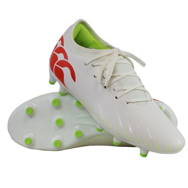 A pair of Canterbury Speed Falcon Team FG soccer cleats in Snow White/Tangerine Tango, featuring green studs, a lime green interior, and tangerine red heel accents, displayed against a white background.