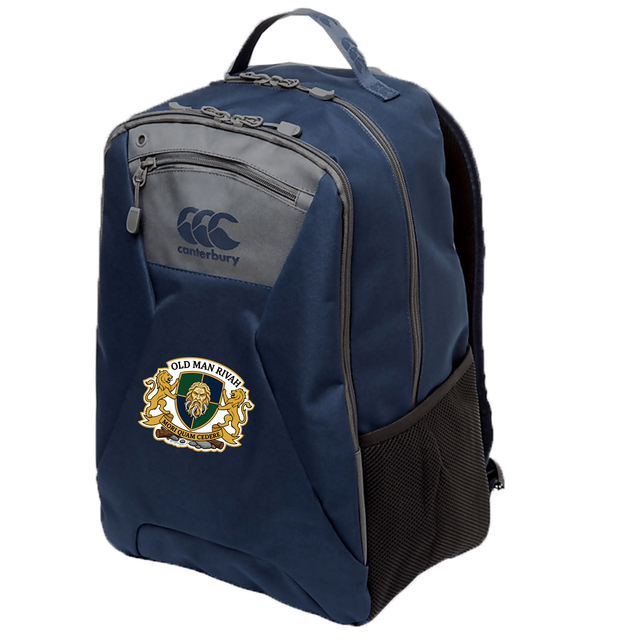 The Old Man Rivah Rugby Medium Backpack by EMB Canterbury is navy blue, with a zippered front pocket, mesh side pocket, padded laptop pocket, and features the club crest on the front.