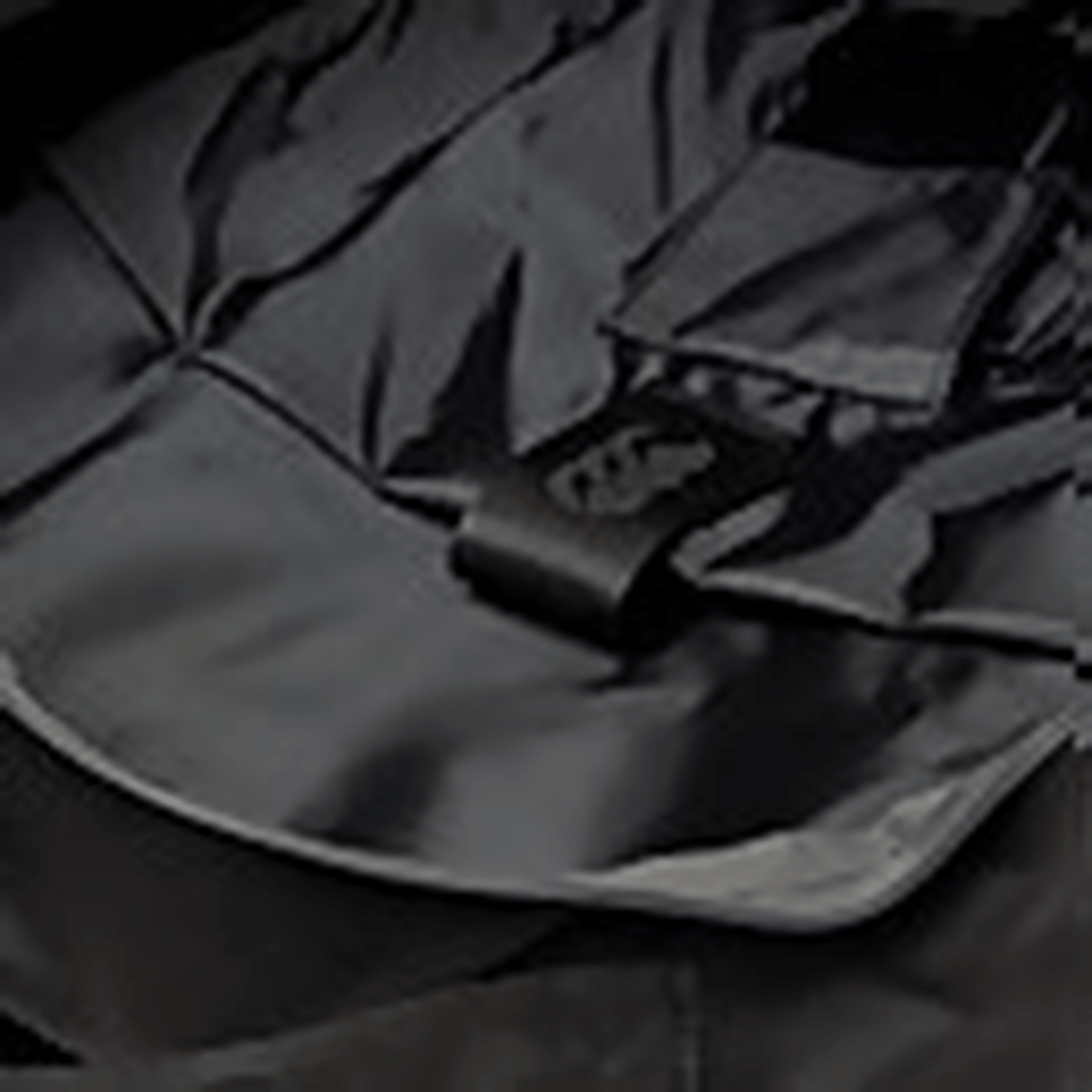 A close up of a Canterbury Medium Backpack with a cell phone in it.