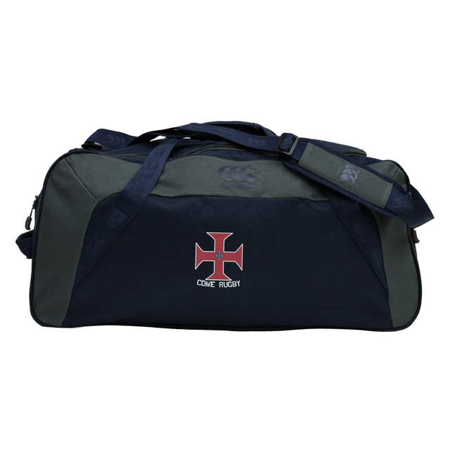 Introducing the SF CDME Rugby Holdall Duffle Bag by Canterbury. This large, navy blue and gray duffle from EMB Canterbury features a convenient shoulder strap, bold red and white cross logo, and prominent "COVE RUGBY" text on the front. Designed as a practical, water-repellent holdall, it’s ideal for keeping your rugby gear dry on and off the field.