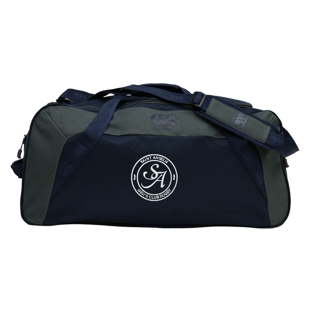 The Saint Anselm College Club Rugby Holdall Duffle Bag by EMB Canterbury features navy and gray colors, dual handles, an adjustable shoulder strap, a water-repellent finish, and a bold "Saint Anselm Rugby" front logo.
