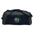 The Kingwood Rugby Holdall Duffle Bag by EMB Canterbury is a dark blue and gray, water-repellent bag with a shoulder strap and a crest logo of a crown, tree, and sports figures on the front—ideal for rugby essentials.