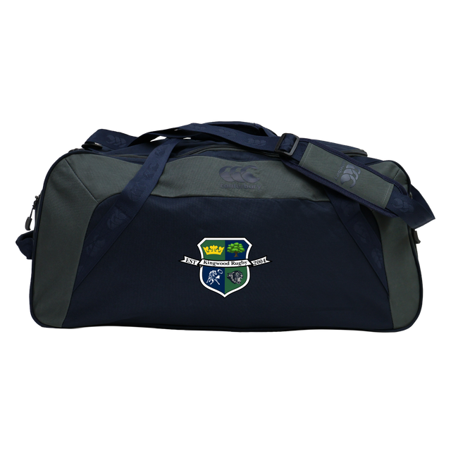 The Kingwood Rugby Holdall Duffle Bag by EMB Canterbury is a dark blue and gray, water-repellent bag with a shoulder strap and a crest logo of a crown, tree, and sports figures on the front—ideal for rugby essentials.