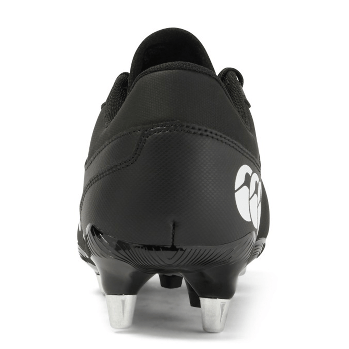 A rear view of the Canterbury Junior Raze SG Boot in black and white, featuring metal studs and a white logo on the heel—ideal for young players on soft ground.