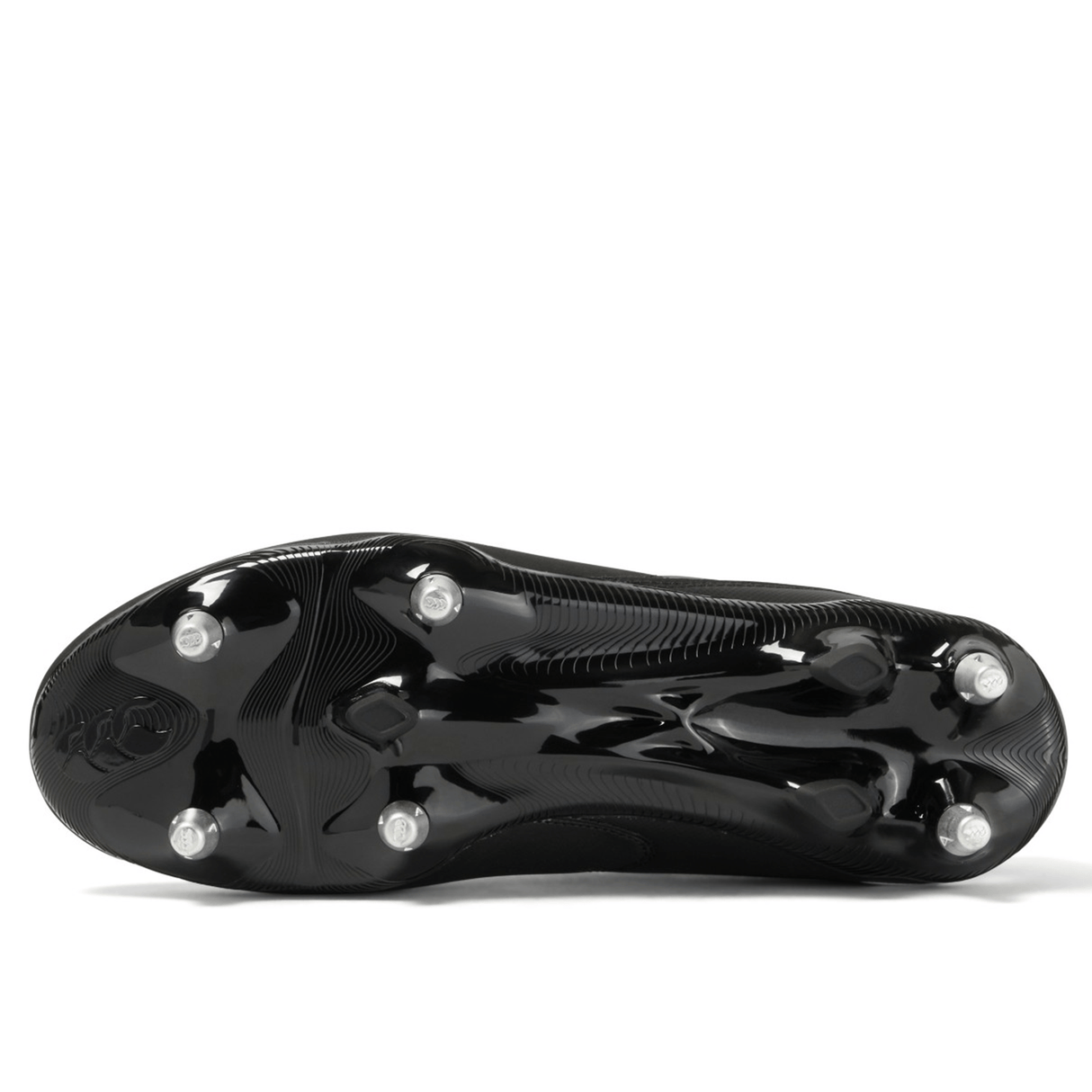 The bottom view of a black and white Canterbury Phoenix Raze SG Boot, featuring high-traction metal studs for optimal performance on soft ground.