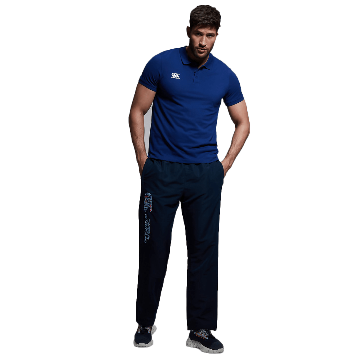 A man in a blue shirt and black Canterbury CCC Uglies Open Hem Stadium Pant.