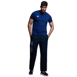 A man in a blue shirt and black Canterbury CCC Uglies Open Hem Stadium Pant.