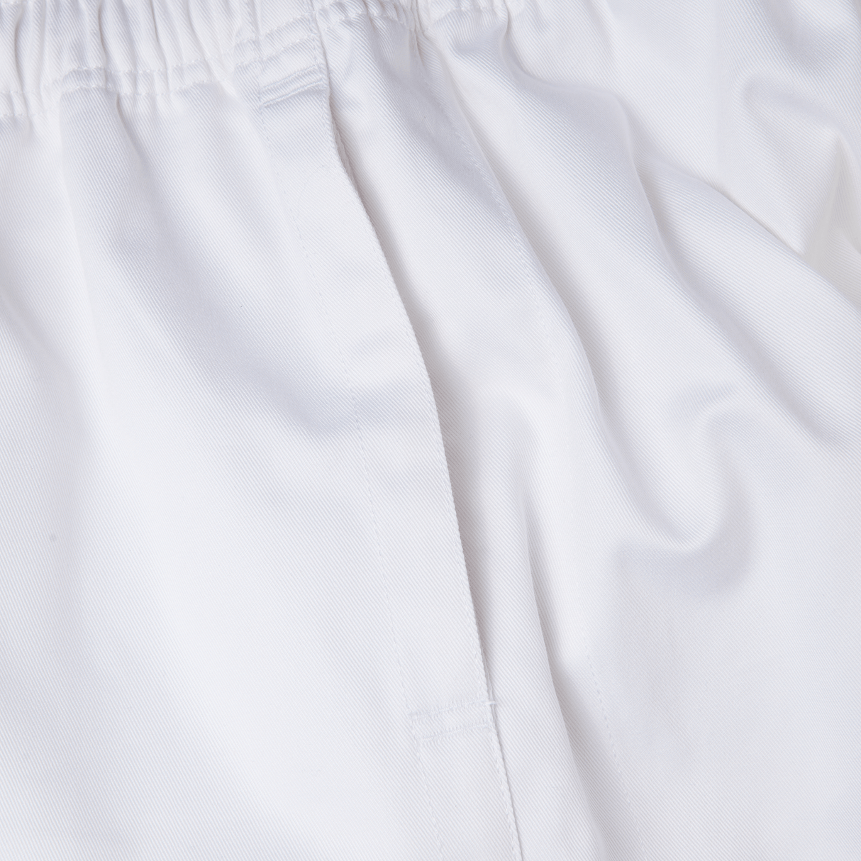 Close-up of Canterbury Professional Cotton Shorts from Bundle Canterbury, featuring a white cotton short with an elastic waistband and stitching detail.