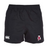 Introducing the University of Alabama Rugby Player's Drill Short by EMB Canterbury: athletic shorts crafted from recycled fabric, featuring a black color with an elastic waistband. They sport a white logo and a red and white triangular emblem, combining style with sustainability.