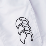 A white jacket with a black logo on it, perfect for pairing with Canterbury Tactic Shorts on the rugby pitch.