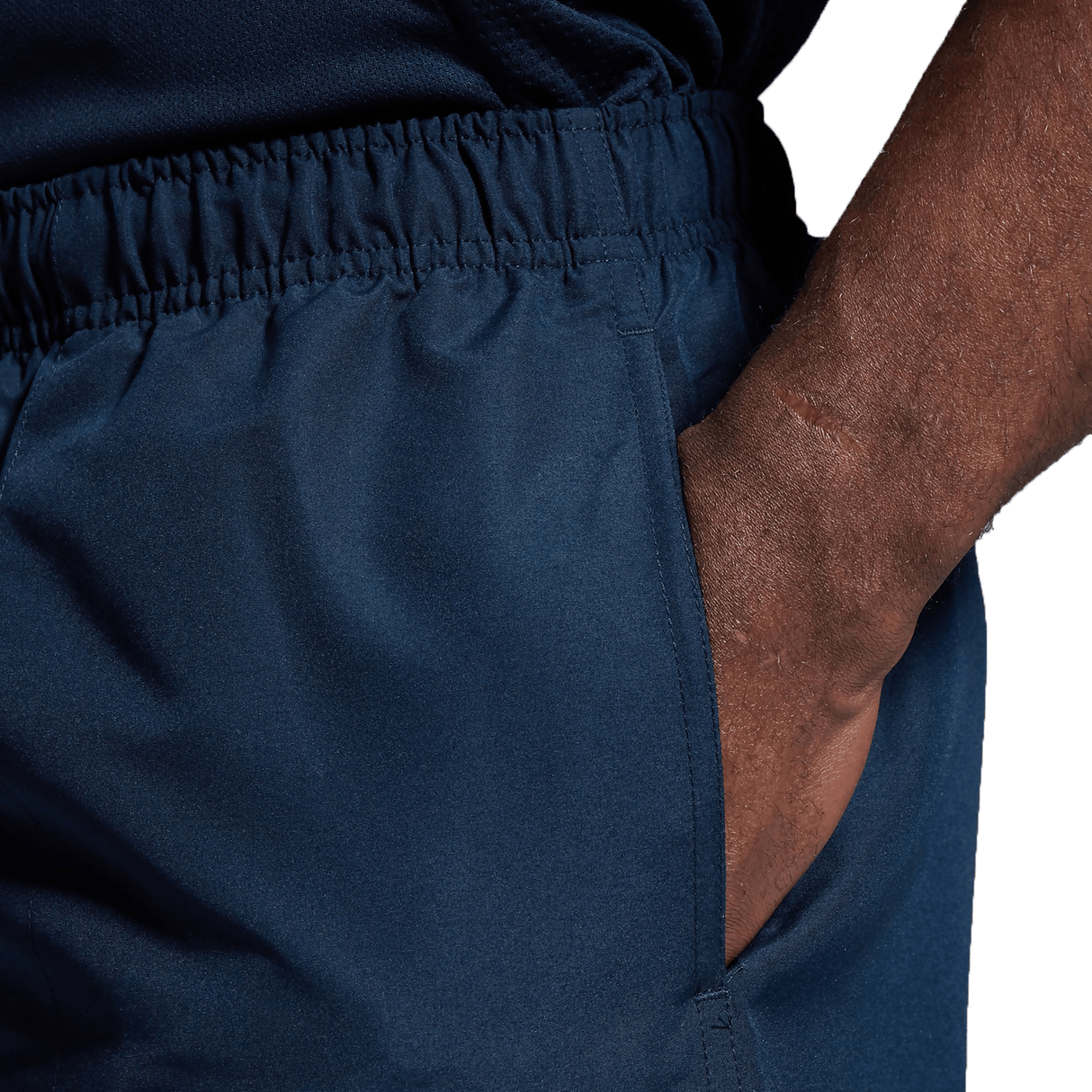 A close up of a man's Canterbury Tactic Shorts with his hand on his hip.