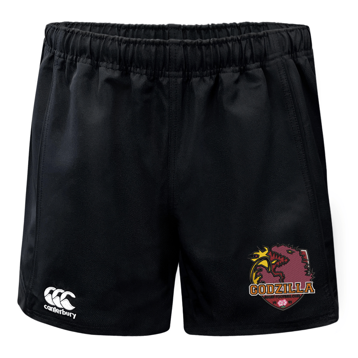 Introducing the Godzilla Rugby Football Club Advantage Rugby Shorts by EMB Canterbury—black athletic shorts with an elastic waistband, showcasing the Canterbury logo on the left leg and a bold “Godzilla” dragon logo on the right. Designed for superior moisture wicking, these rugby shorts ensure comfort both on and off the field.
