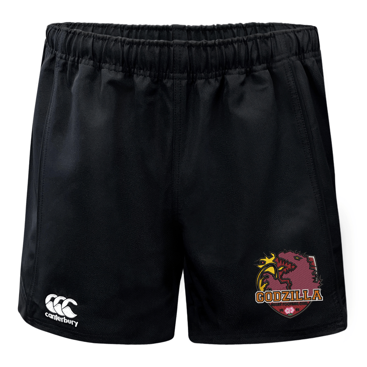 Introducing the Godzilla Rugby Football Club Advantage Rugby Shorts by EMB Canterbury—black athletic shorts with an elastic waistband, showcasing the Canterbury logo on the left leg and a bold “Godzilla” dragon logo on the right. Designed for superior moisture wicking, these rugby shorts ensure comfort both on and off the field.